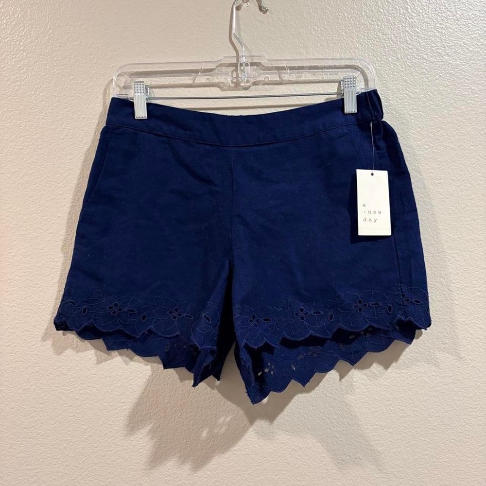 Navy blue shorts with lace trim and scalloped hem